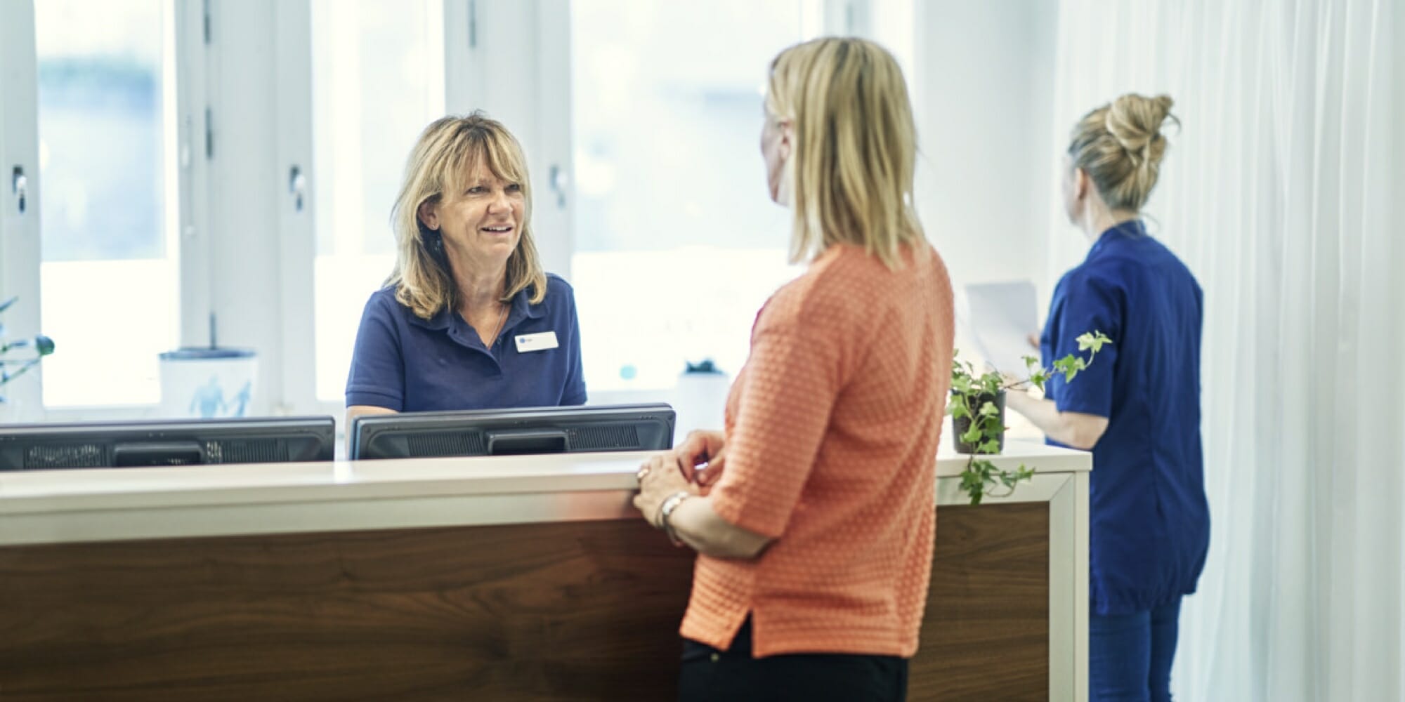 A woman working in healthcare talking to another woman