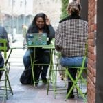 A woman working with a laptop outdoors