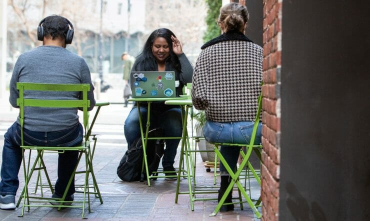 A woman working with a laptop outdoors