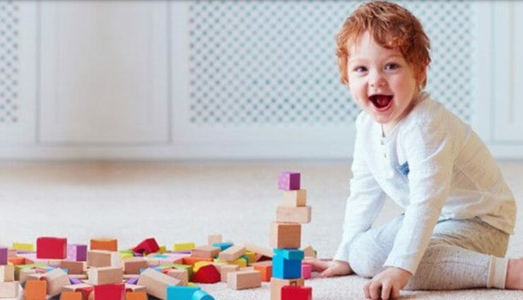 A baby playing with toy blocks