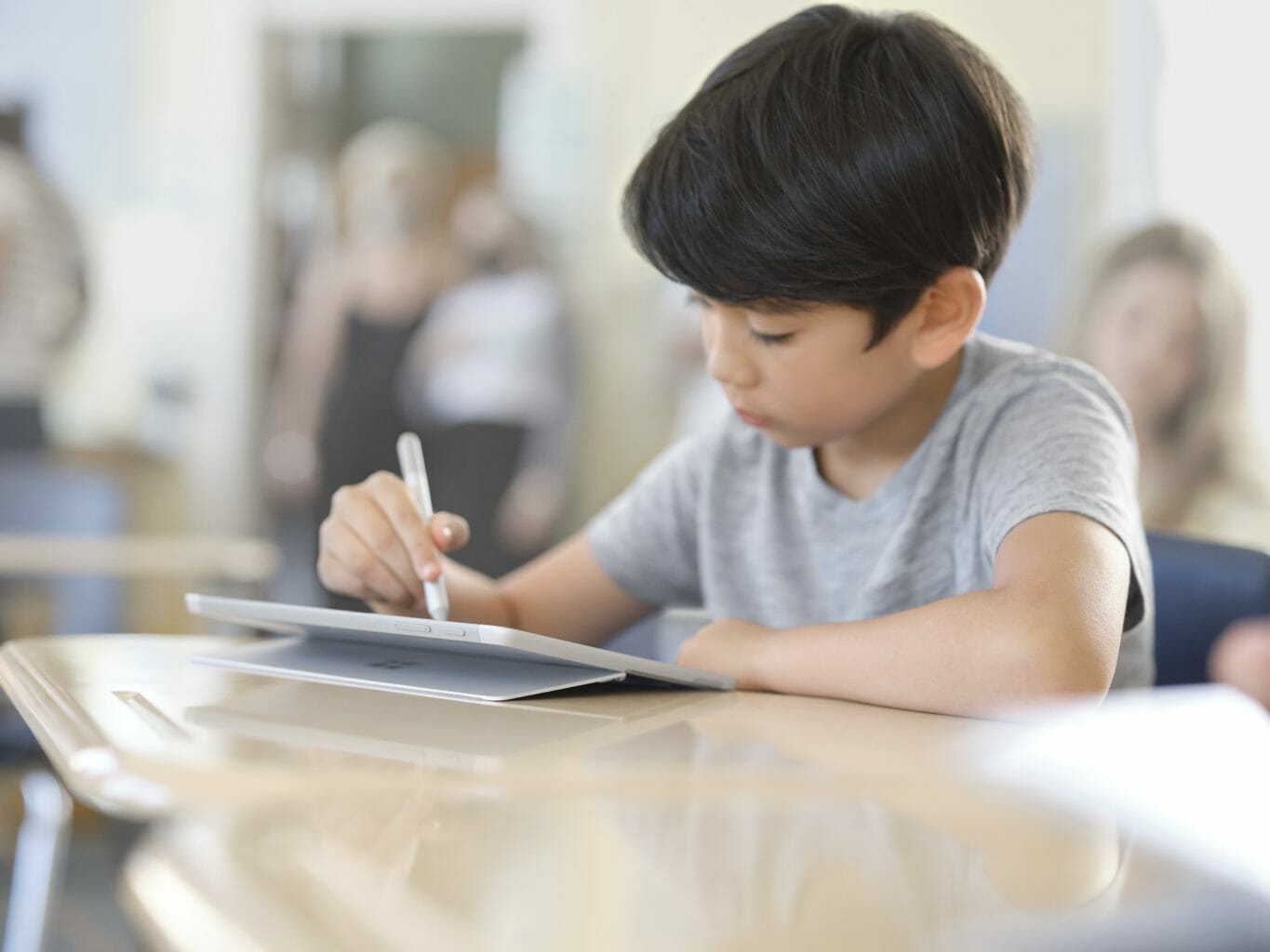 Joung male with Surface Go 3 in School