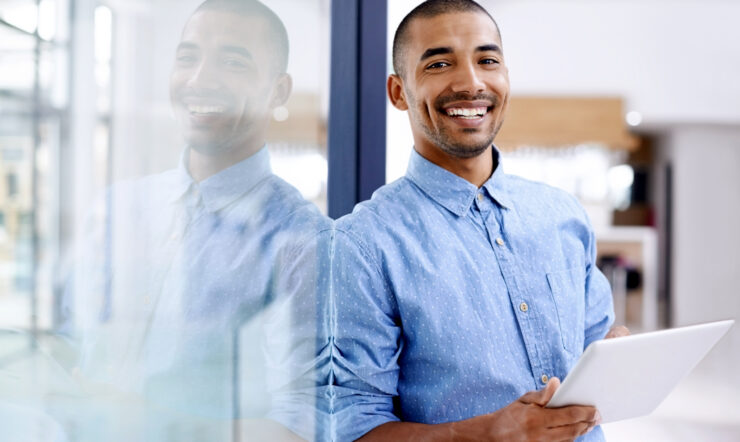 Shot of a young entrepreneur using a digital tablet in a modern office.