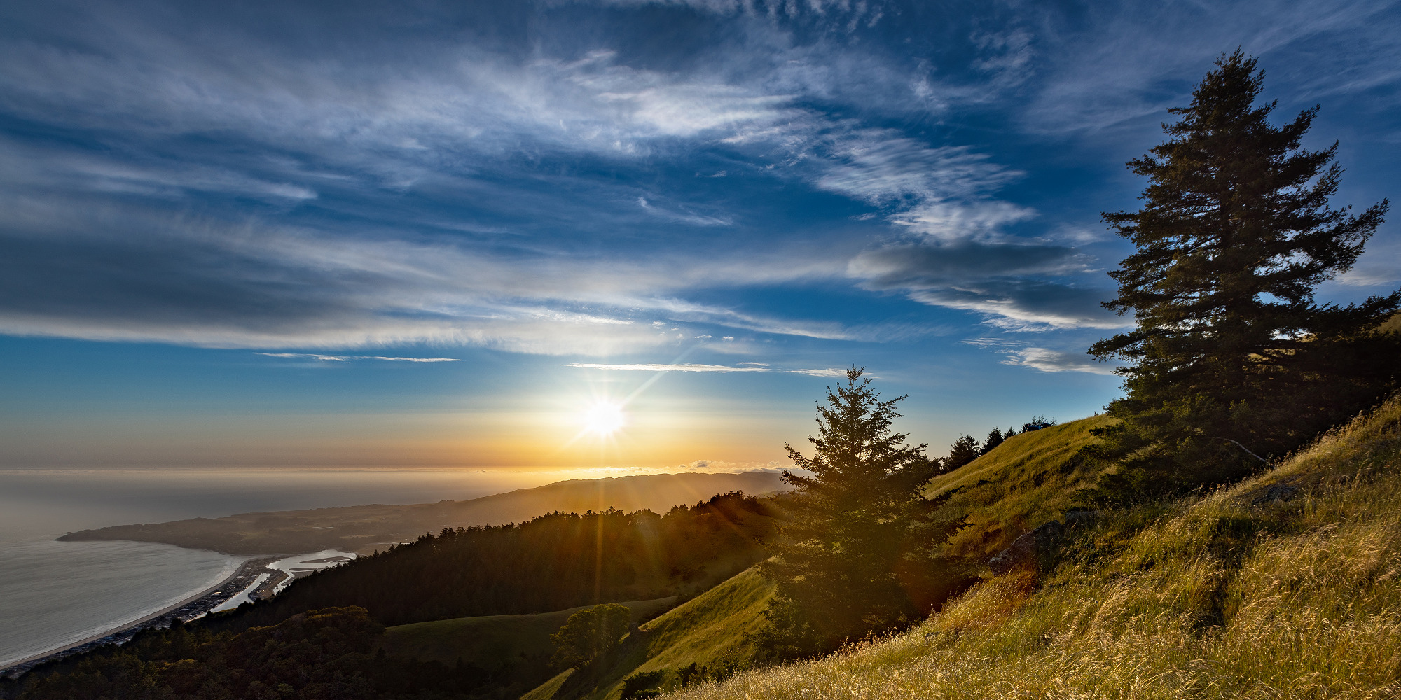 Expansive view of ocean coast at sunset across the foothills in Mount Tamalpais State Park, Mill Valley, California