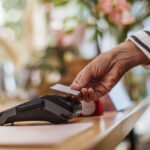 a hand on a transaction machine