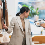 Two women in a furniture shop looking at color tones on a tablet