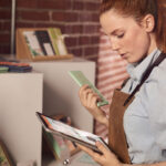 female shopkeeper looking at her work tablet