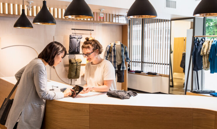 Shopkeeper tending a customer in a clothing store