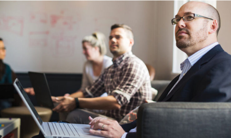 Several person sitting and watching in front
