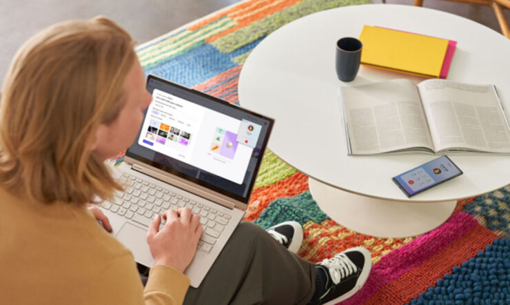 person sitting next to laptop