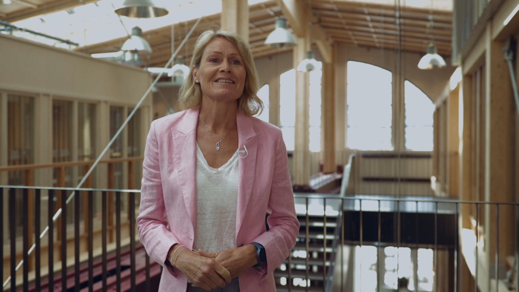 Woman in pink suit at an office