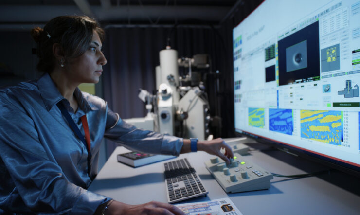 A women in a lab staring focused at a screen