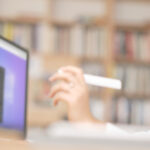 Worker at a desk, looking at a computer monitor